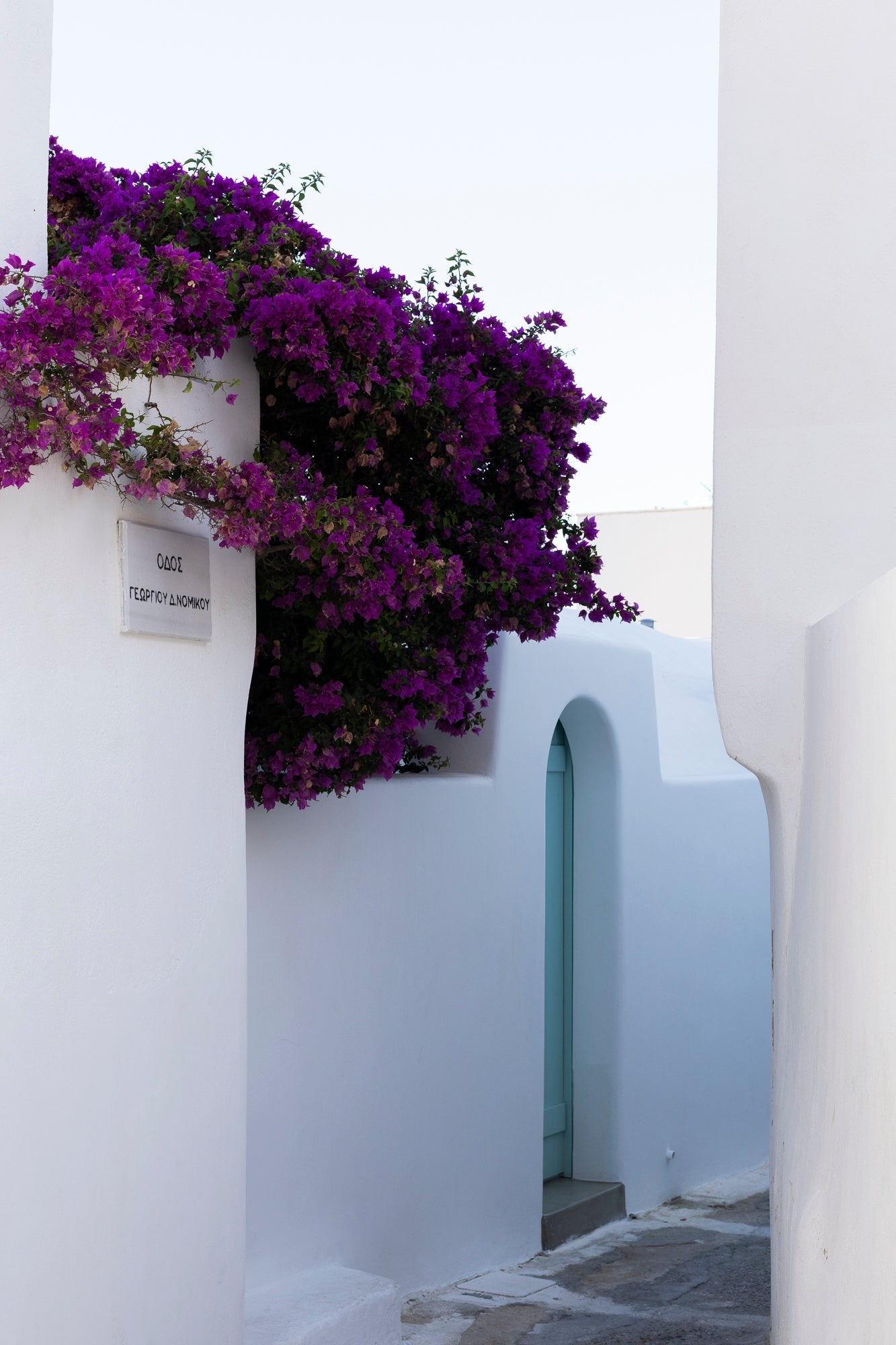 Bougainvillea and whitewashed alley in Emborio, Santorini