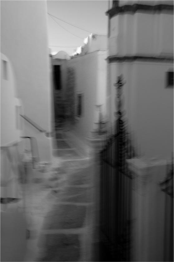 Abstract black and white photograph of a narrow Cycladic passage in Emborio, Santorini