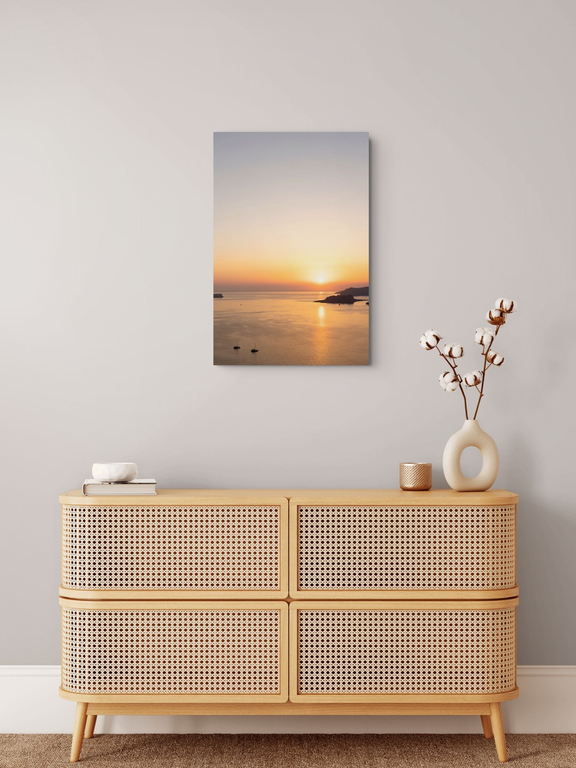 Minimalist Santorini sunset over the Aegean Sea with golden light reflecting across calm water.