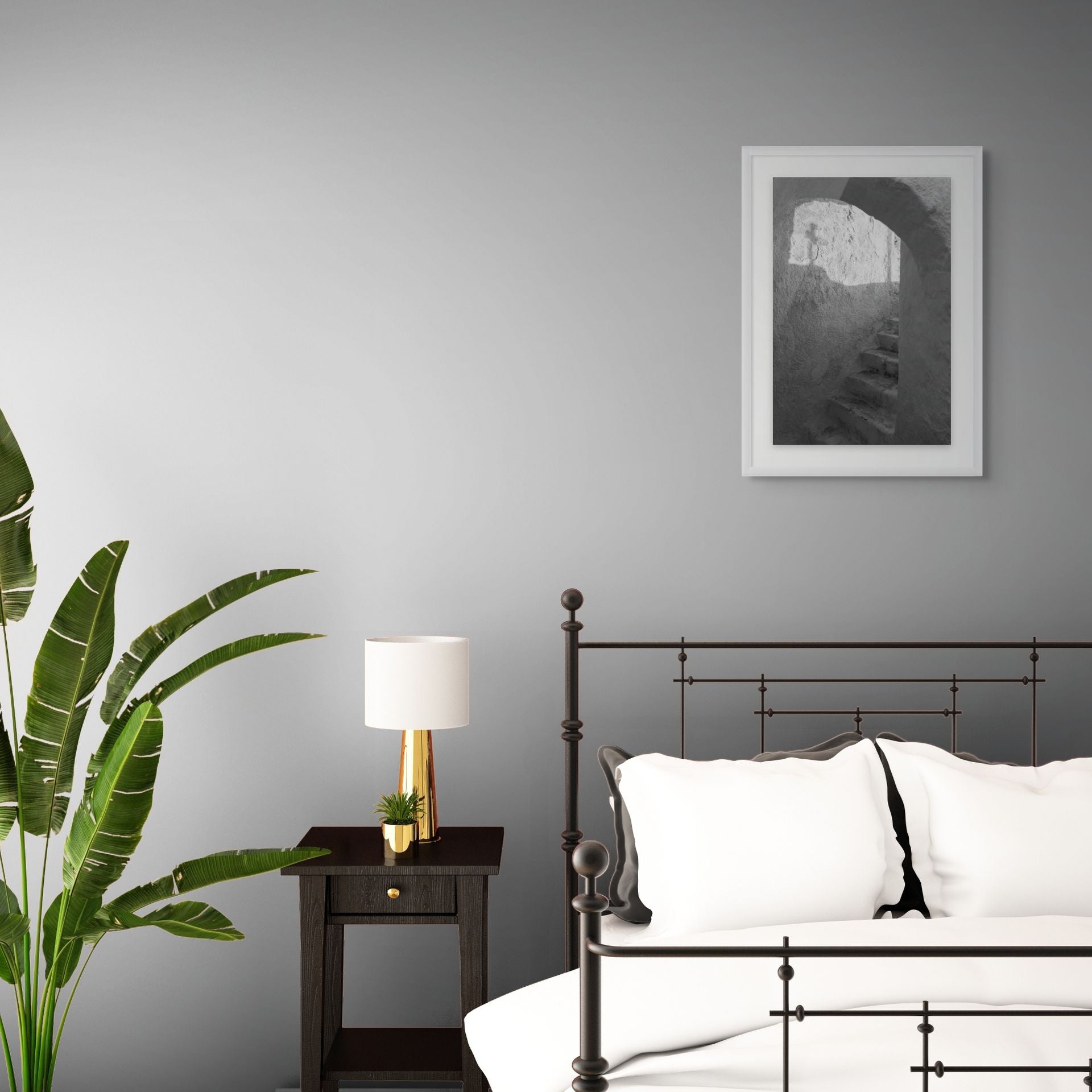 The Passage black and white Santorini fine art print displayed in a modern bedroom with white walls and minimalist decor